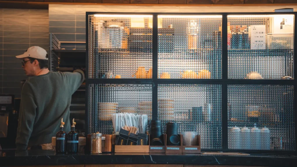 A barista at a caf&eacute; counter