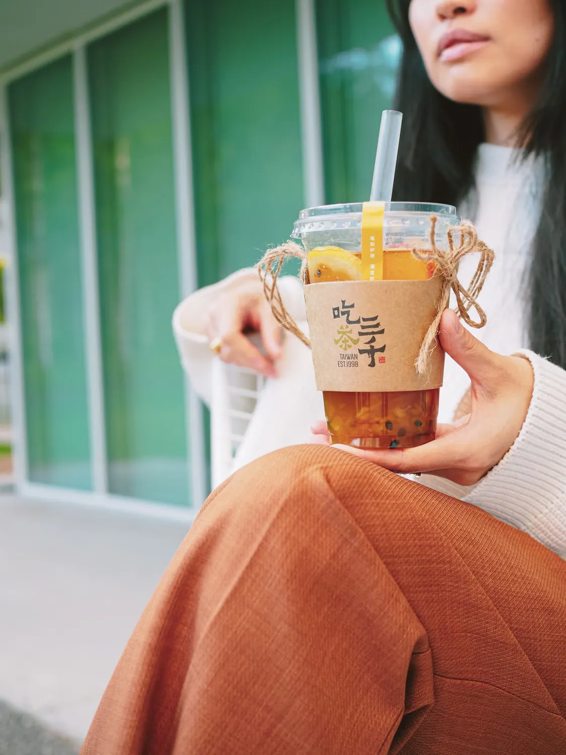 A customer holding a takeaway drink